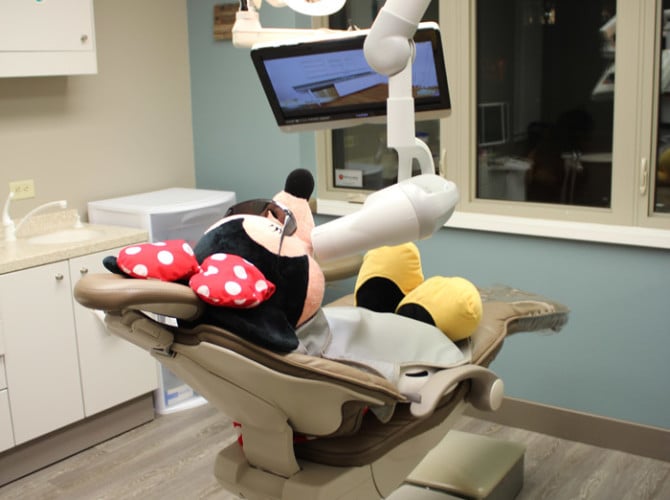 mini mouse in a dental chair